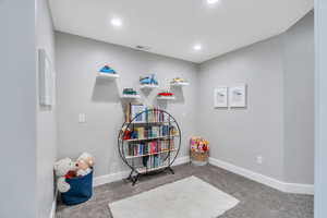 Downstairs nook with carpet and recessed lighting
