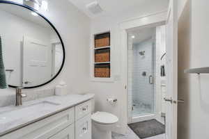 Downstairs Full bathroom one of two with a walk-in shower, vanity, and recessed lighting
