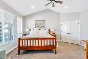 Master Bedroom featuring carpet flooring, a ceiling fan, vaulted ceiling, a  walk-in closet, and recessed lighting