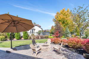Fall View of patio featuring an outdoor fire pit