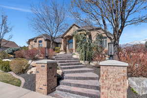 View of front of house with brick siding and a mountain view
