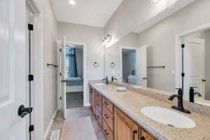 Jack and Jill Bathroom with double vanity, and  tile  floors