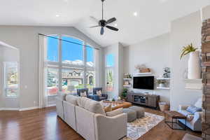 Great room featuring a ceiling fan,  hardwood flooring, and a vaulted ceiling