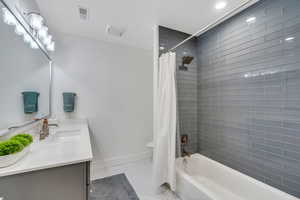 Downstairs Full bathroom, two of two with vanity, shower / bathtub combination,  tile floors, and recessed lighting
