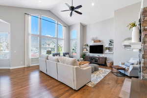 Great room featuring hardwood floors, a ceiling fan, and vaulted ceiling