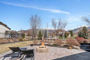 View of patio / terrace with an outdoor fire pit and a mountain view