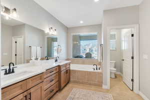 Master Bathroom featuring double vanity, a Jetted tub, and recessed lighting