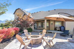 View of patio / terrace with an outdoor fire pit and a mountain view