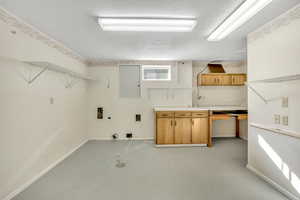 Laundry area with concrete flooring, hookup for a washing machine, and hookup for a gas dryer