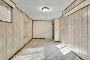 Unfurnished room with wooden walls