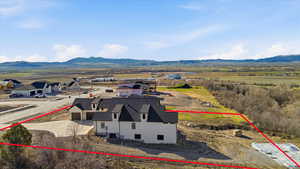 Aerial overview of property's location with property parcel outlined and a mountain backdrop
