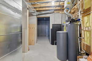 Unfinished below grade area featuring a water softener system