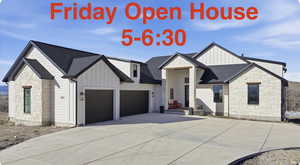 View of front of home featuring stone siding, board and batten siding, and roof with shingles
