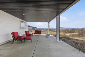 View of covered patio with a mountain view