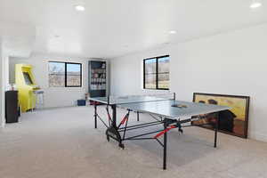 Game room featuring light carpet, healthy amount of natural light, and recessed lighting