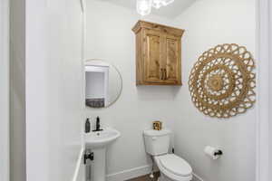 1/2 Bathroom featuring toilet and baseboards