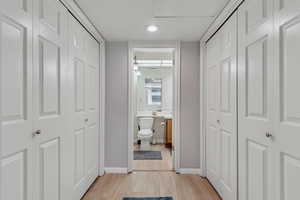 Hall featuring light wood-style floors and baseboards