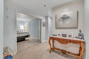 Hallway with light wood finished floors and baseboards