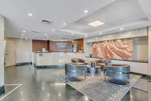 Reception featuring a raised ceiling and recessed lighting