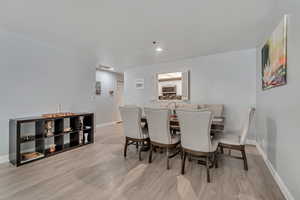 Dining area featuring light wood-style floors and recessed lighting