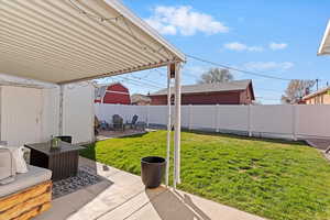 Fenced backyard featuring a patio