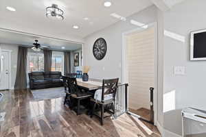 Dining room featuring wood finished floors, a ceiling fan, and recessed lighting