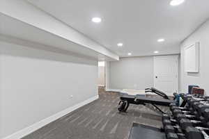 Exercise room with recessed lighting and dark colored carpet