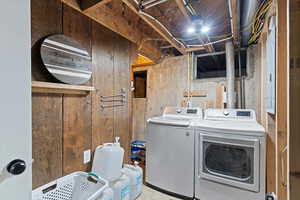 Laundry area featuring separate washer and dryer and electric panel