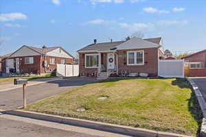 Bungalow-style house with brick siding and a chimney