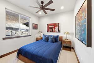 Bedroom featuring a ceiling fan, recessed lighting, and light carpet