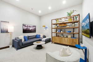 Living room with light carpet and recessed lighting