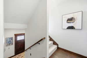 Stairway featuring wood finished floors and baseboards