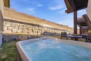 Exterior view of a jacuzzi and a mountainous background