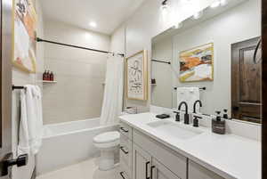 Full bath with vanity, shower / bathtub combination with curtain, and recessed lighting