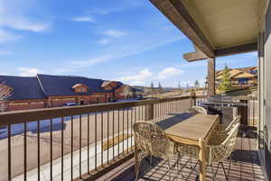 Balcony with outdoor dining space and a residential view