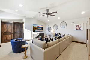 Living area with ceiling fan, light carpet, lofted ceiling, and recessed lighting