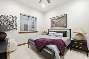 Bedroom with light colored carpet and a ceiling fan