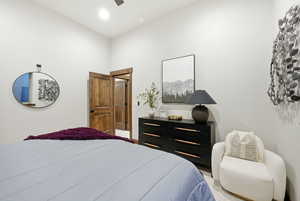 Bedroom featuring a ceiling fan and light carpet