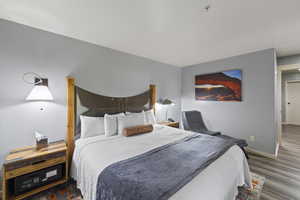 Bedroom with baseboards and wood finished floors