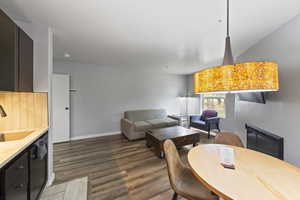 Dining area featuring a glass covered fireplace and light wood-style floors