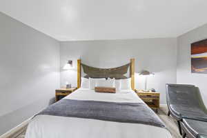 Bedroom with light wood-style floors and baseboards