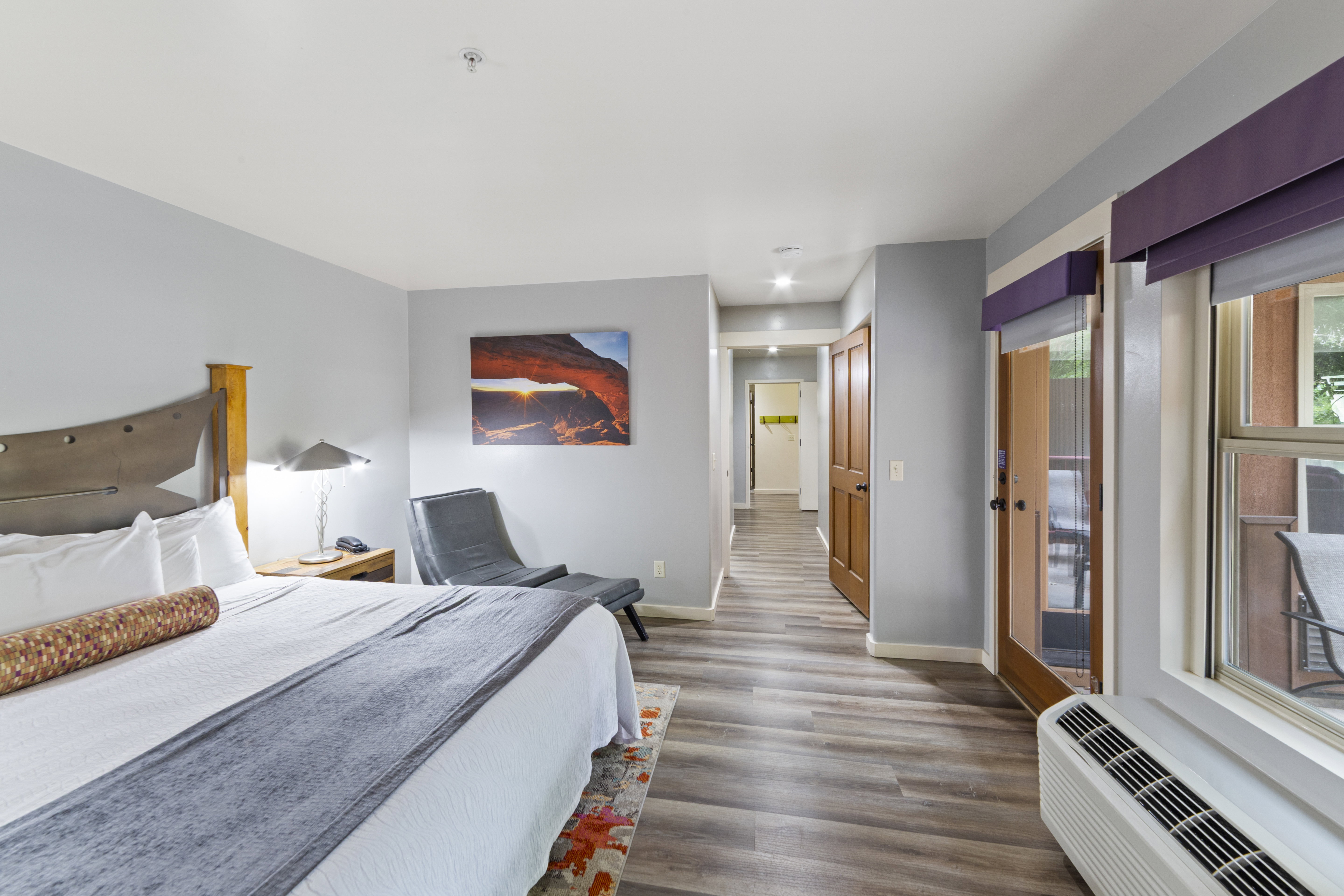 Bedroom with access to exterior and dark wood-style floors