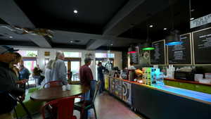 Bar area with pendant lighting and dark cabinets