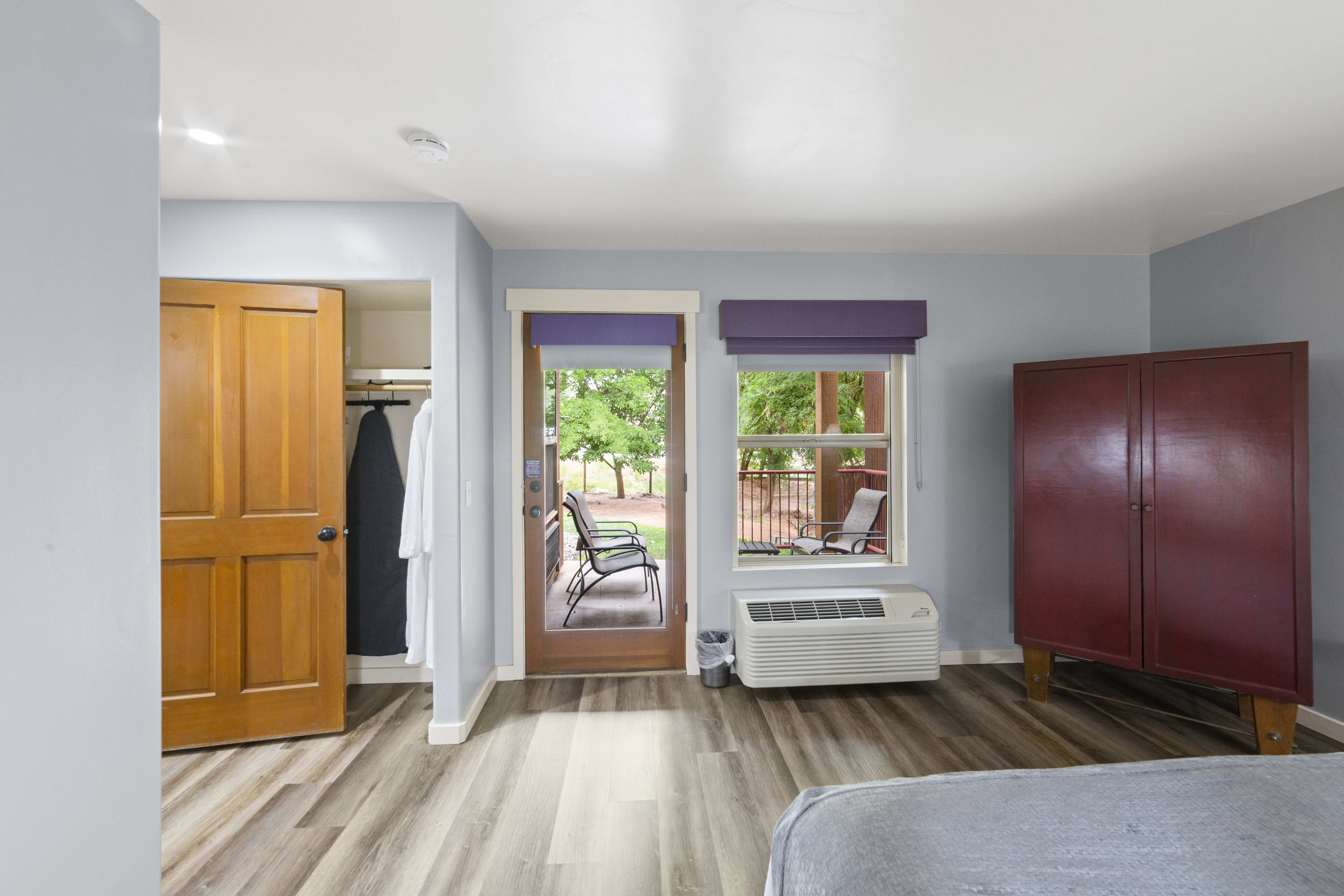Bedroom featuring wood finished floors, a closet, and access to outside
