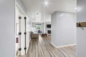 Corridor featuring light wood-type flooring and baseboards