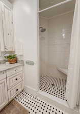 Bathroom featuring vanity, a shower stall, and light tile patterned flooring