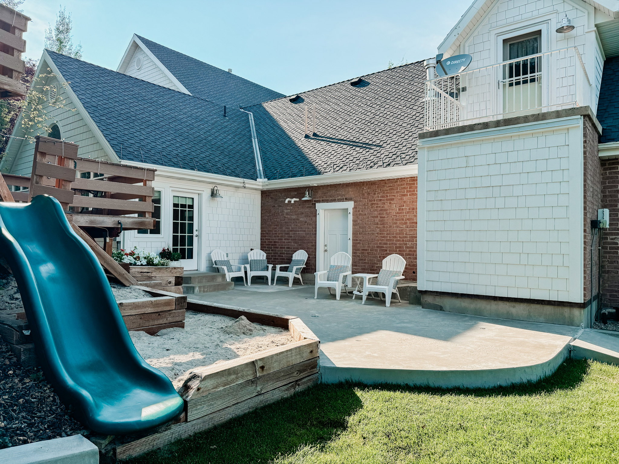 Back of property featuring a patio area and a shingled roof