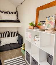 Bedroom featuring carpet floors and lofted ceiling