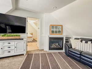 Upstairs Family room with a fireplace and light colored carpet