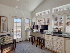 Office space featuring lofted ceiling and light wood-style floors
